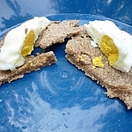 Camp meal: A poached egg on a round piece of flatbread, cut in half.