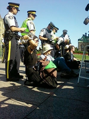 Officers arresting the second wave of Keystone XL pipeline protesters on Parliament Hill.