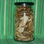 Jar of dehydrated Ontario apples against a green background with red and white stripes
