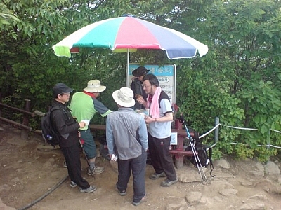 If the old man from that bus ride near Jeonju had seen this crowd of hikers gathered around a vendor's cart on a mountain peak, he wouldn't have worried about me hiking alone.