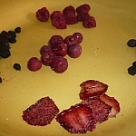 An assortment of dehydrated berries piled onto a yellow plate