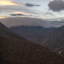 Clouds hugging a mountaintop, seen while hiking in Baños.