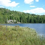 One of the Brush Lakes, with a forested hill in the background
