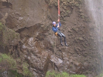 Dangling in the air while repelling down a waterfall.