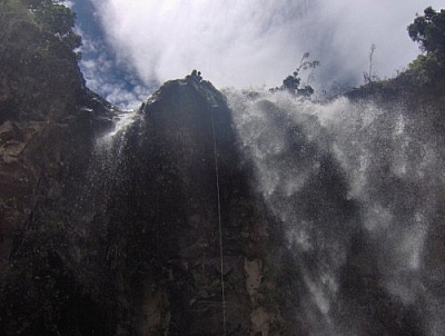 View from the bottom looking up at the last set of falls while repelling in Baños.