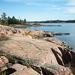 Pink granite smoothly lining the blue waters of Georgian Bay along Chikanishing Creek Trail