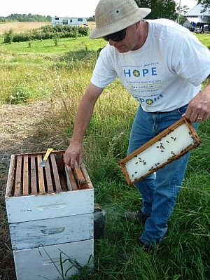 Dan handling trays wearing jeans and a t-shirt.