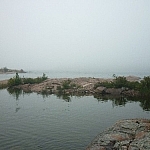 A grey sky is barely distinguishable from the grey waters of Georgian Bay near Killarney's East Lighthouse.