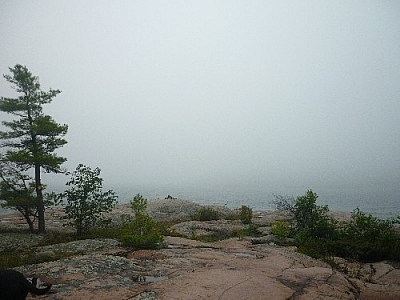 A foggy Georgian Bay hides just past a pink granite rock outcrop near Killarney's East Lighthouse.