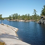 Rocky shoreline of winding waters at Grundy Lake Provincial Park.