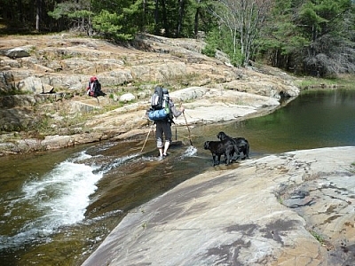 Marc wading into a shallow stream on our first day trekking Killarney's La Cloche Silhouette loop trail.