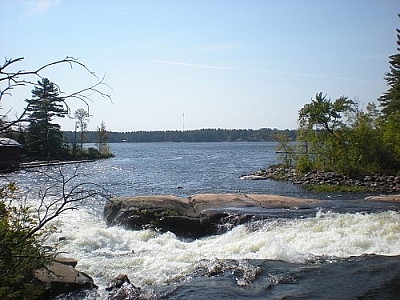 View of Meshaw Falls and an old wooden building, by Matt Vrijburg.