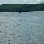 A closer view of a canoe on Semiwite Lake, seen from the trail.