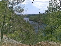 Scenic view of a river flowing into the forest in the distance at Samuel de Champlain Park.