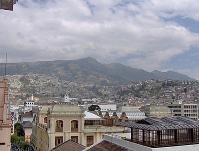 View of the city of Quito nestled against a backdrop of mountains, from the Monestario de Santa Catalina