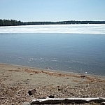 A thin layer of ice covers Lake Nipissing, a narrow strip of water exposed near Lapin Beach.