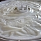 Vanilla yogurt spread out on a dehydrator sauce sheet.