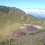 A volcanic crater at Hallasan National Park, containing only a little water at the time of my visit.