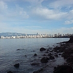 The Pacific Ocean and the downtown skyline with a mountainous backdrop, as seen while exploring Vancouver.