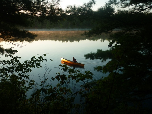 A canoeist heading out for a morning paddle on Big Clear Lake.