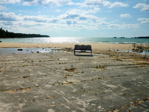 A bench overlooking Misery Bay sits on a stretch of coastal alvar pavement.